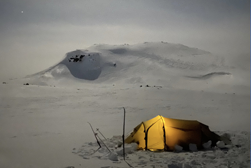 tent at twilight, lit from inside